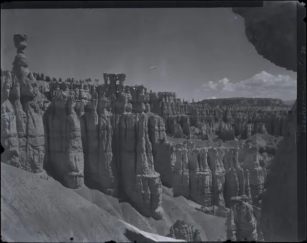Nitrate negative of Thors Hammer from below the rim in BRCA. Hoodoos in background. ; BRCA Museum and Archives Image BRCA8875_001_298 ; BRCA 8875