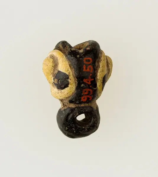 Amulet in form of human face