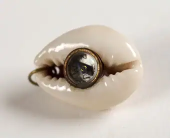 Compass encased within a shell, good luck charm