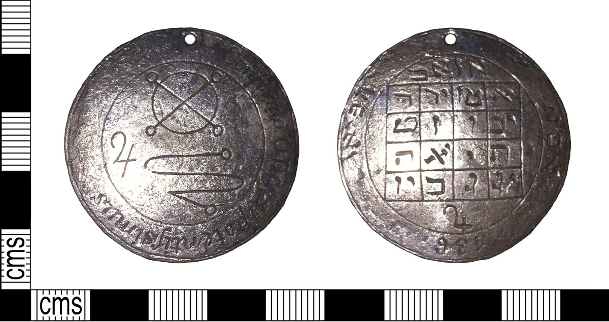 A copper-alloy medallion with a magic square